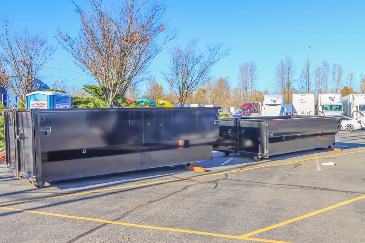 Professional dumpster rental service with roll-off container on residential driveway in Kerrville